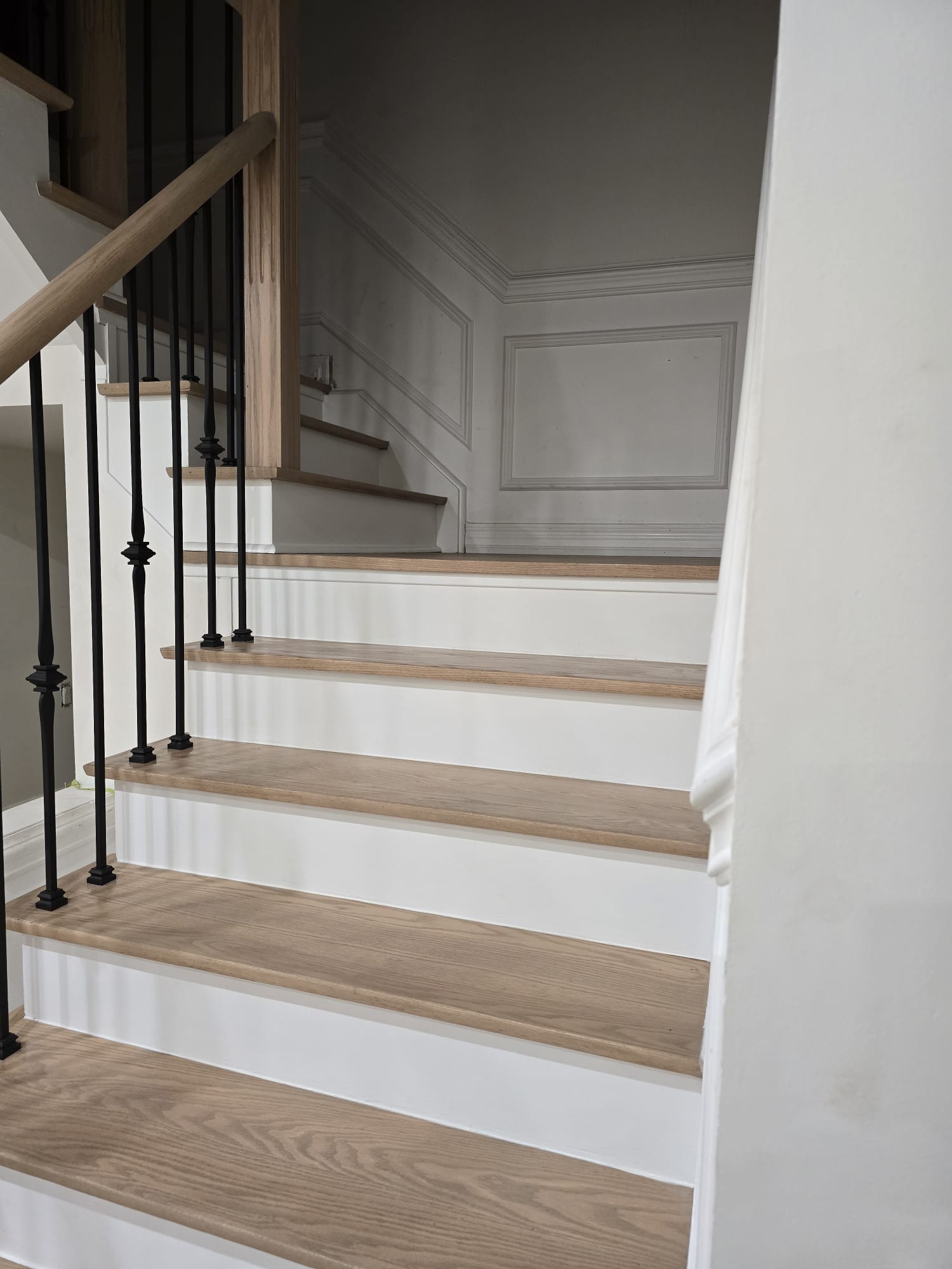 Hardwood stair flooring detail with matching risers and landing transition