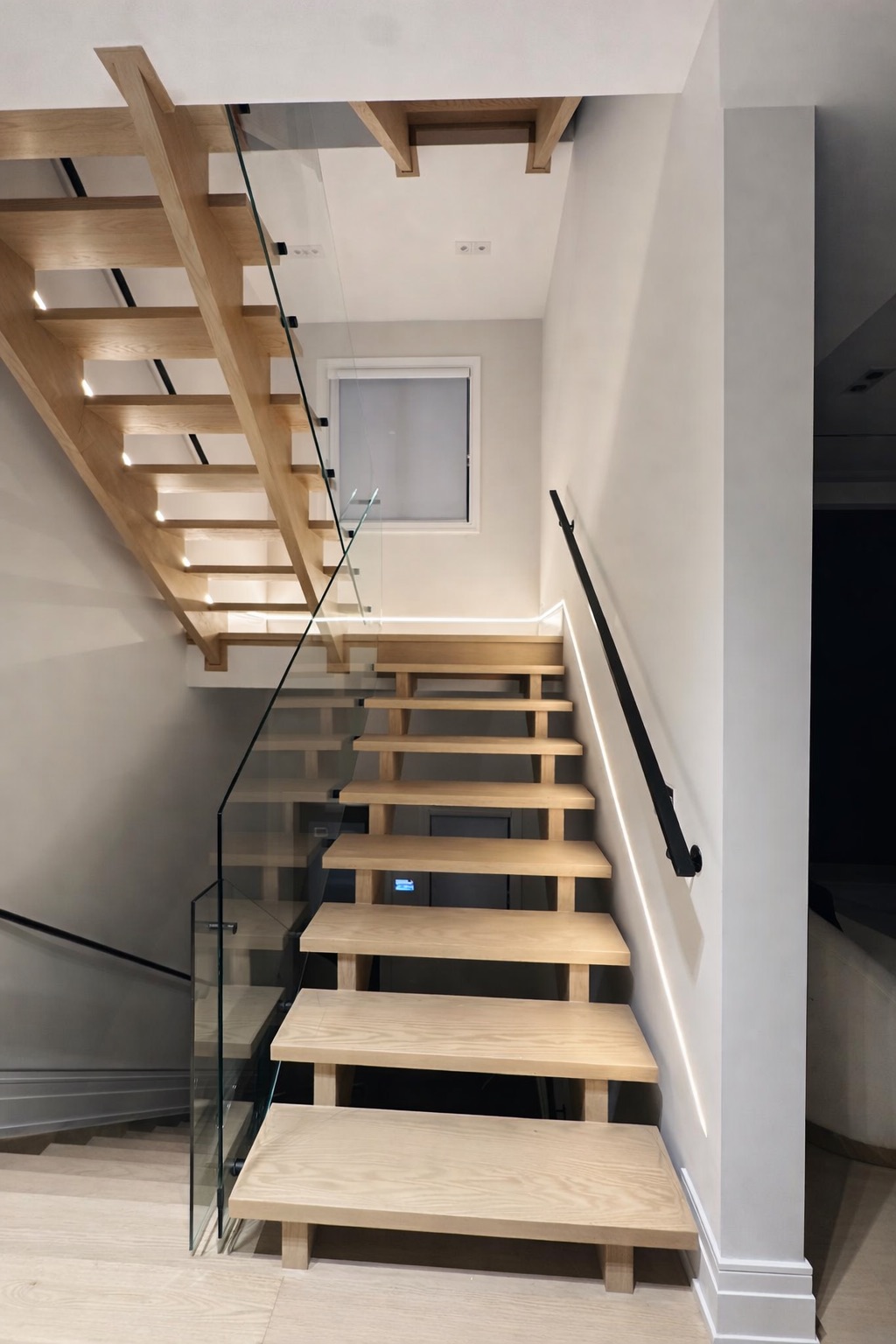 Hardwood staircase installation with matched tread finish and side profile detail